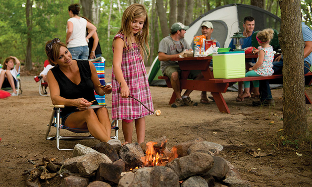 a family around a camp fire at Sandy Pines