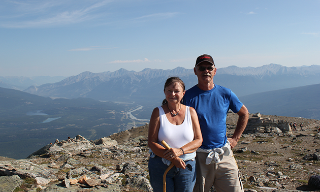 Photo of a couple at the top of Whistler's Mountain in Jasper, Alberta.