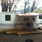 Husband and wife standing in front of their RV