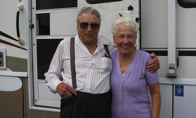elderly couple in front of a motorhome
