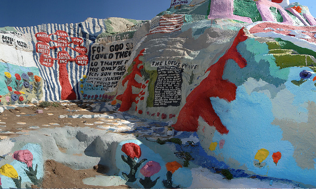 Colourful man-made mountain of clay painted with primitive religious symbols