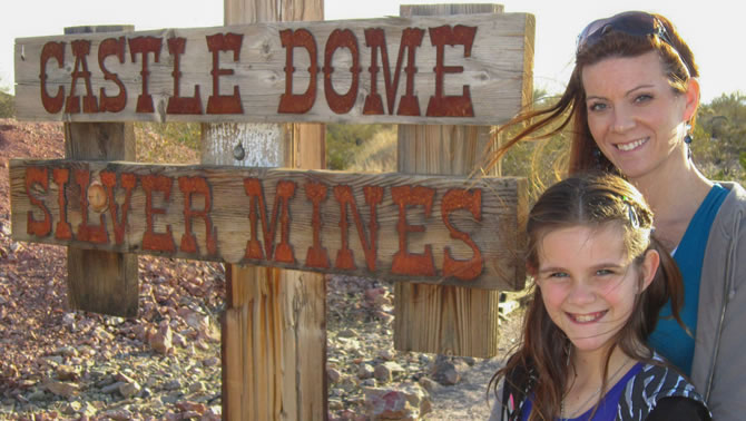 Mother and daughter Jena and Haley Jones stand in front of the Castle Dome Silver Mines sign.