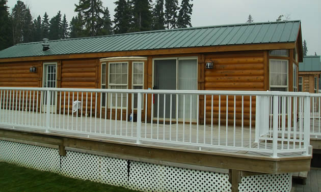 Park model RV with a full-length fenced deck