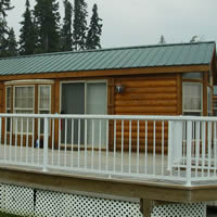 Park model RV with a full-length fenced deck