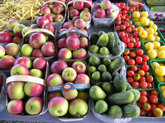 Fresh apples, zucchinis and cherry tomatoes at a stand in the Bancroft, ON farmers' market.