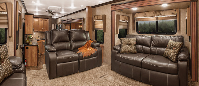 A view of the living room with two leather couches in the Durango Gold fifth wheel