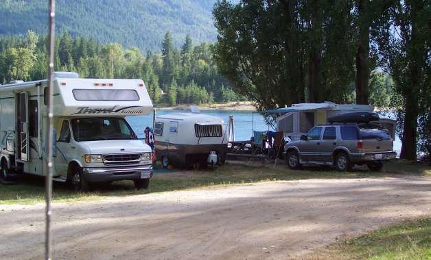 My husband and I were visiting the Nelson/Balfour area for the first time in our 1970-something Boler travel trailer. On arrival at the campsite, we were assigned a lakefront spot and when we parked, we were the only people there; however, as we set up camp, neighbours arrived to the left and to the right of us. Once we had set up camp, we decided to take a drive to Balfour and as we were pulling out of our campsite, I looked back at our trailer and this picture is what I saw. The difference in size between us and our neighbors really tickled our funny bones. We've now graduated to a 28' fifth wheel but we still talk about our little Boler, how much fun we had in it and how simple life was back then.