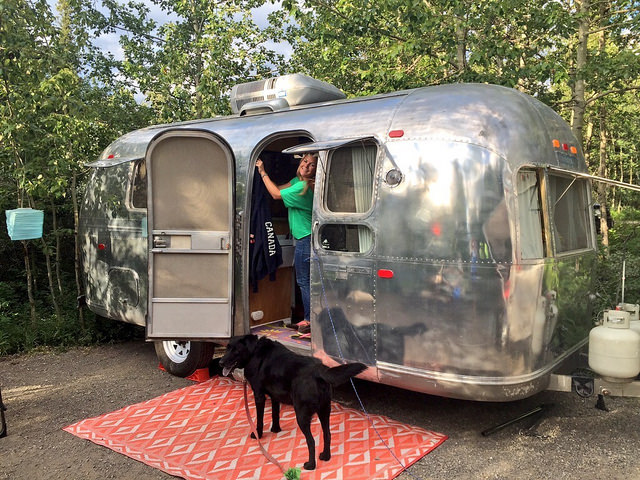 Anne Bovon is in the doorway of the couple's vintage airstream.