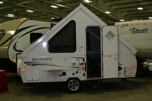 A small tent trailer that pops up to look like a triangle.
