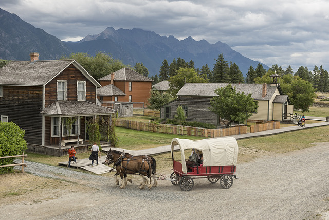 A covered wagon going on a street at Fort Steele heritage town near Cranbrook, BC.