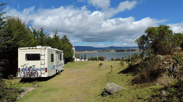 A photo of Sherman, the Read's motorhome overlooking a cliff above the ocean. 