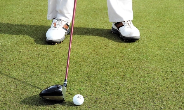 Shot of a golfer making a putt