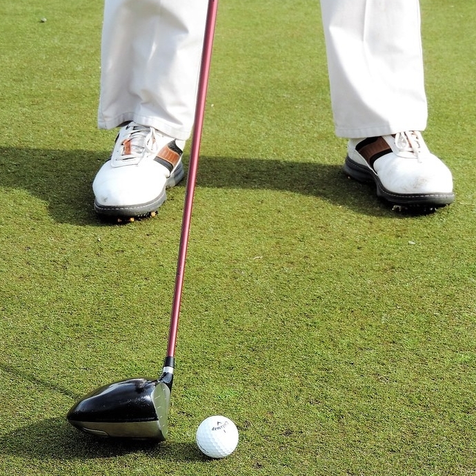 Shot of a golfer making a putt