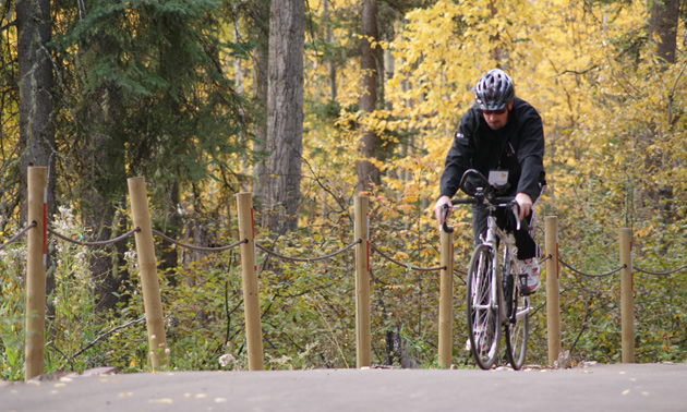 Cyclist enjoying the Community Trail in Fort Nelson, BC