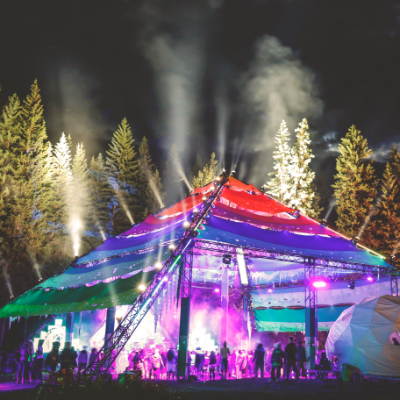 The Motion Notion Festival tent is lit up at night.