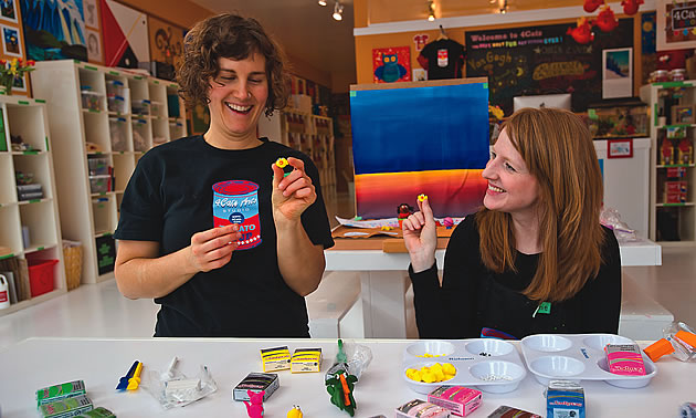 two female artists playing with some paints at 4Cats in Nelson, BC