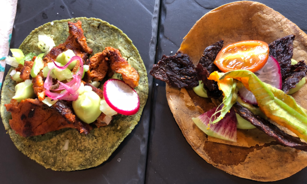 Two tacos are on display on a table