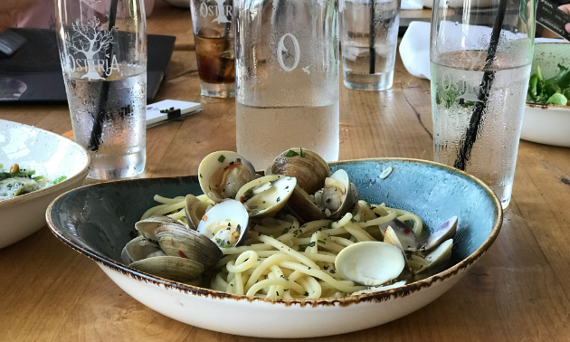 A plate full of oysters is on a table.