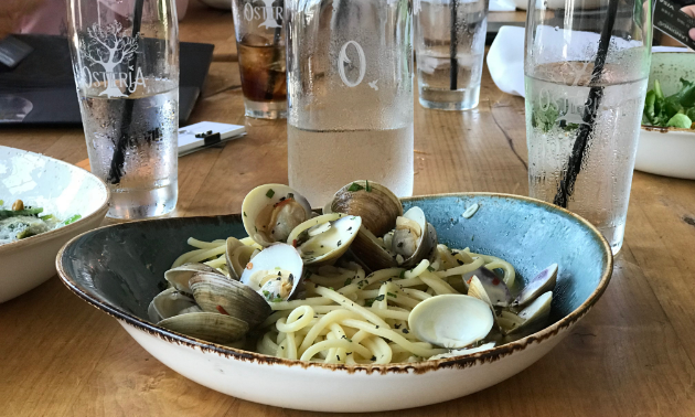 A plate full of oysters is on a table. 