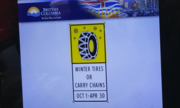 A sign with a picture of a winter tire and the dates Oct. 1 to Apr. 30 inscribed underneath.