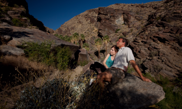 Couple taking a break from hiking at the Indian Canyons.