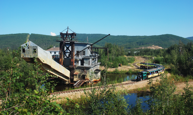 The Tanana Valley Railroad train stops beside Gold Dredge 8 as part of the tour.