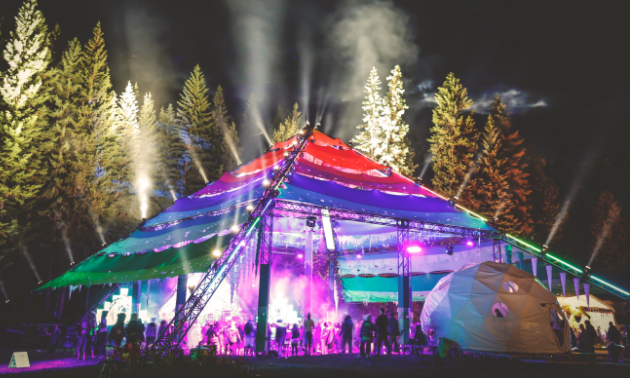 The Motion Notion Festival tent is lit up at night.