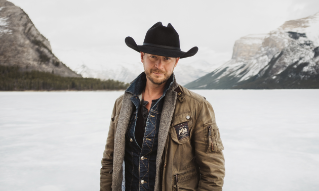 Paul Brandt poses in the mountains in winter