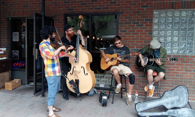 Members of Tidal Baby and OQO jam in front of Record City's new location.