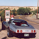 Picture of a Corvette stopped on the side of the Route 66 sign.