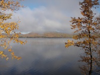View of lake with misty clouds in the background.