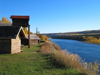 2 cabins on a bluff next to the river.