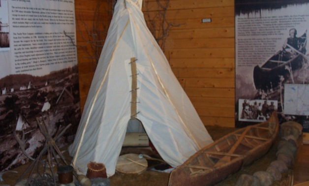 A display of a native tipee and birchbark canoe. 