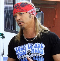 Bret Michaels talking to a couple in front of their RV. 