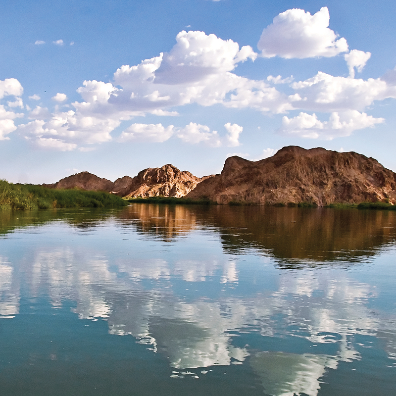 Horizon shot of water and blue sky with mountains in the background - Yuma, Arizona