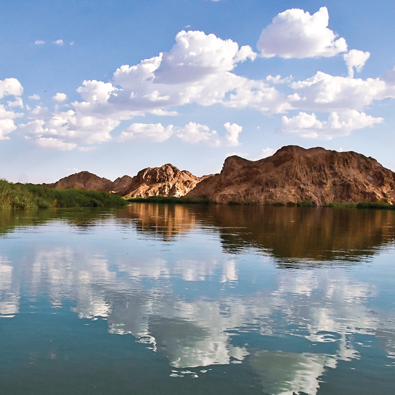 Horizon shot of water and blue sky with mountains in the background - Yuma, Arizona