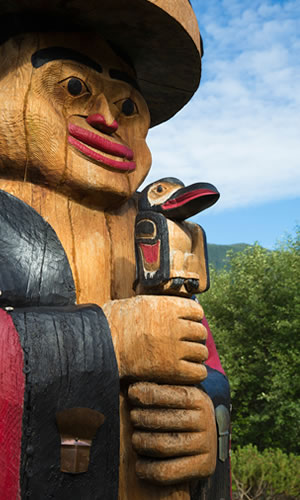 Shown is a large totem pole. 