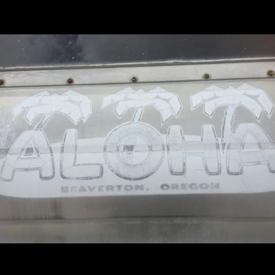 Close-up view of the Aloha Trailer company logo. 