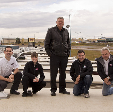 Staff of ArrKann Trailer & RV Centre pose on top of an RV at one of their two Edmonton locations (from left to right: Rob Minarchi, Sarah Baptiste, Ken Friedenberg, Paul Hopkins and Dave Hill). 
 