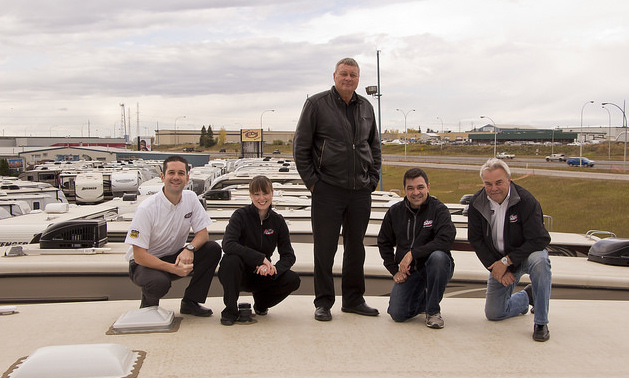 Staff of ArrKann Trailer & RV Centre pose on top of an RV at one of their two Edmonton locations (from left to right: Rob Minarchi, Sarah Baptiste, Ken Friedenberg, Paul Hopkins and Dave Hill).