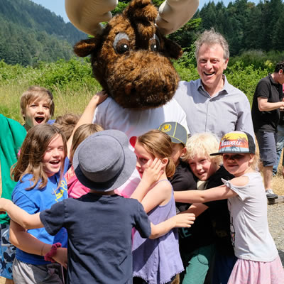 Elementary-age students on a field in a BC park. 