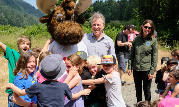 Elementary-age students on a field in a BC park. 