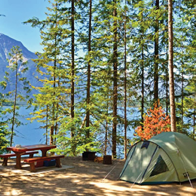 Tent, picnic bench and bike at campsite. 