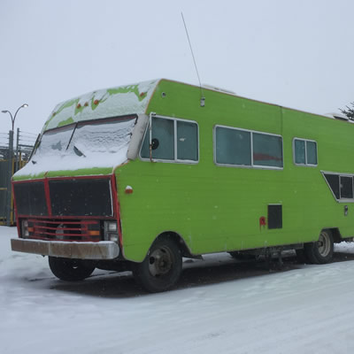 A vintage RV painted bright green. 