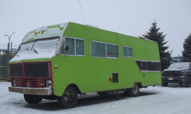 Large motorhome painted green. 