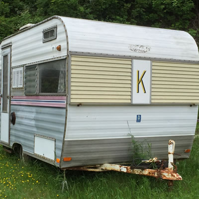 A trailer with a 'K' logo on the front. 