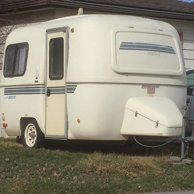 Lil Bigfoot travel trailer, sitting on lawn. 