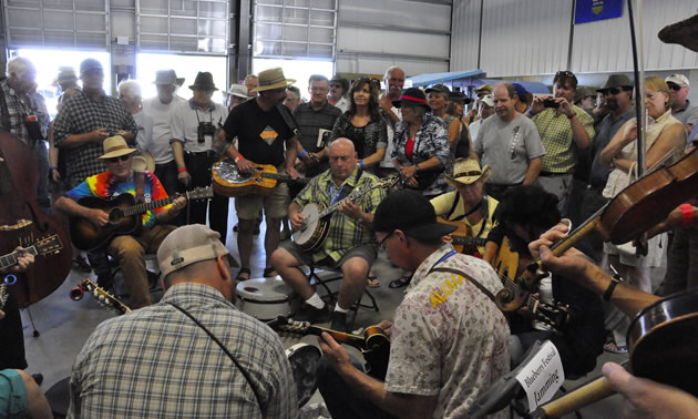 Group of people watching bluegrass jam. 