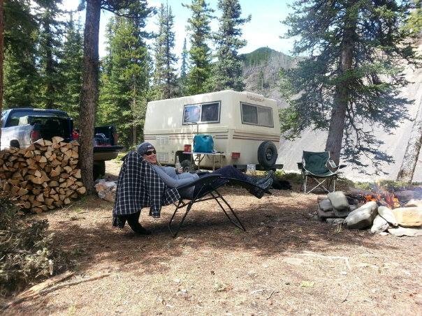 Brandi Giroux sitting in a lounge chair relaxing in front of her RV. 