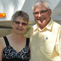 Smiling senior couple beside their RV